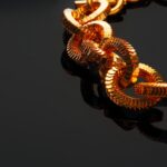 golden chain necklace on black background with ref vtjk95q