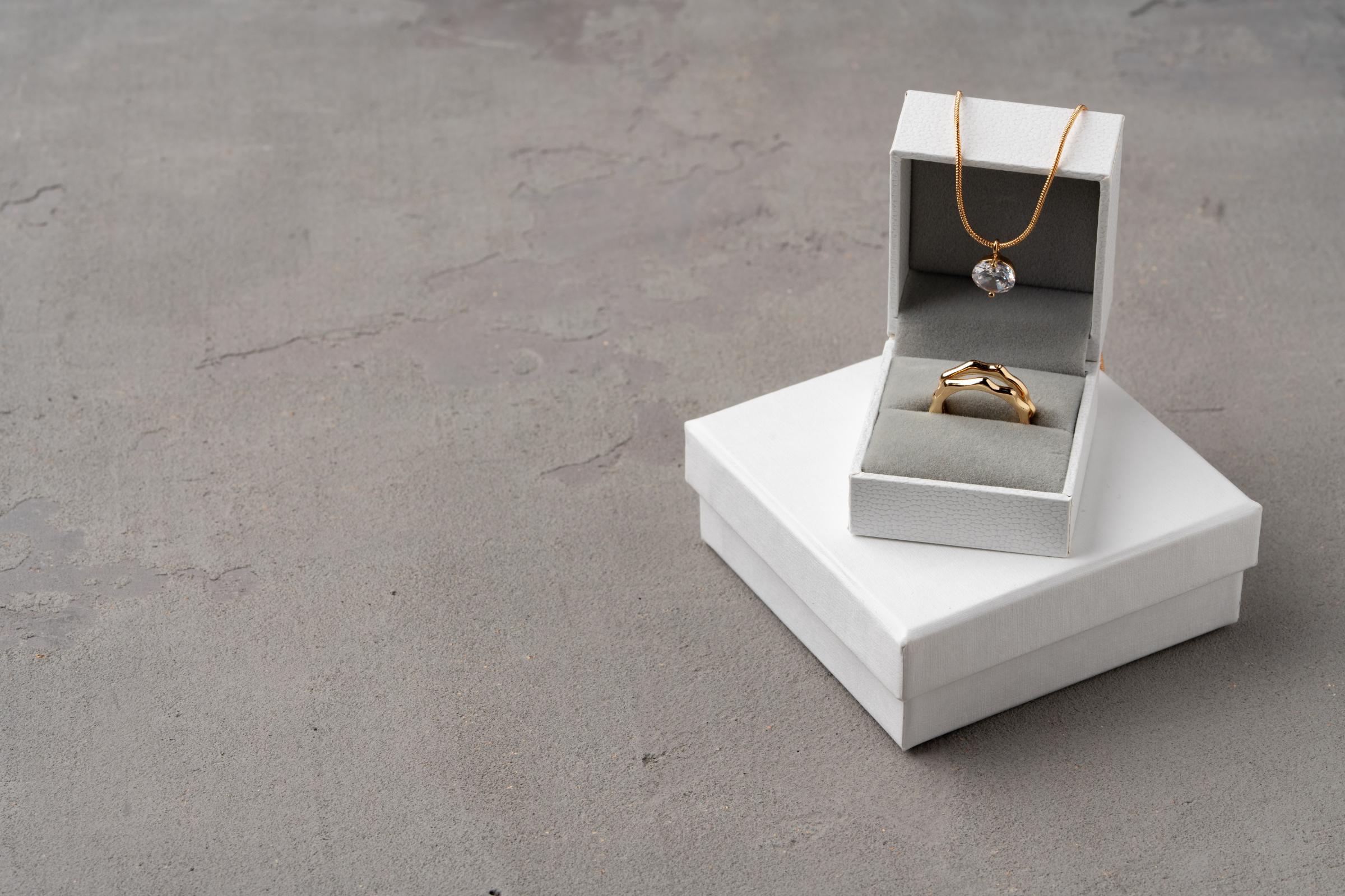 golden jewellery in box on gray background 2023 11 27 05 06 42 utc 1.jpg